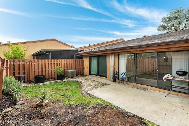 rear view of property with a patio area and central AC unit