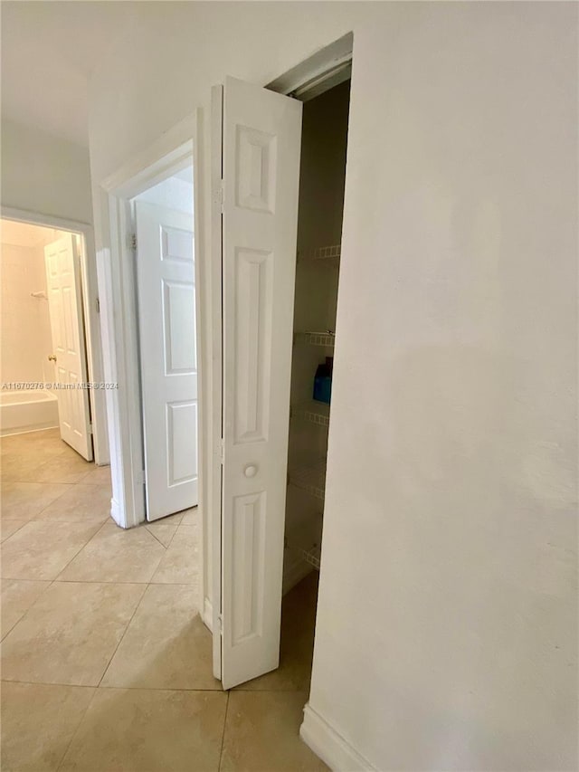 hallway featuring light tile patterned flooring