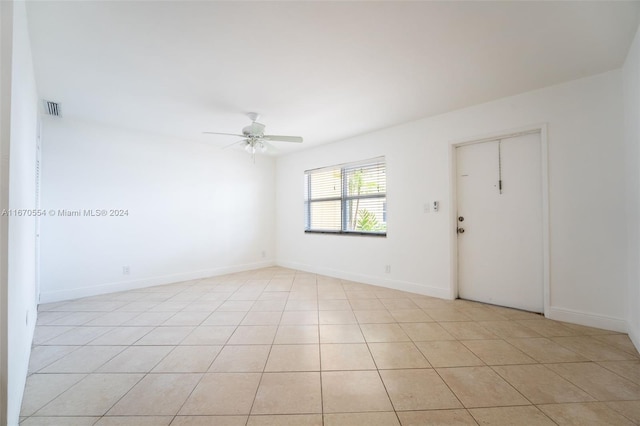 spare room with light tile patterned floors and ceiling fan