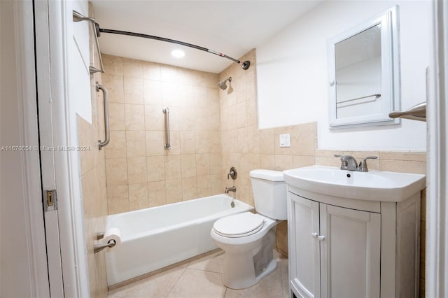 full bathroom featuring tile walls, vanity, tiled shower / bath combo, tile patterned flooring, and toilet