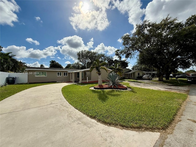 ranch-style home featuring a front yard