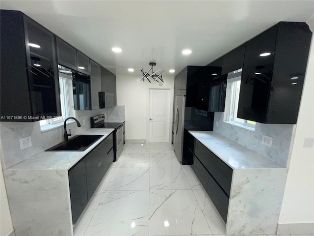 kitchen featuring tasteful backsplash, sink, and stainless steel appliances