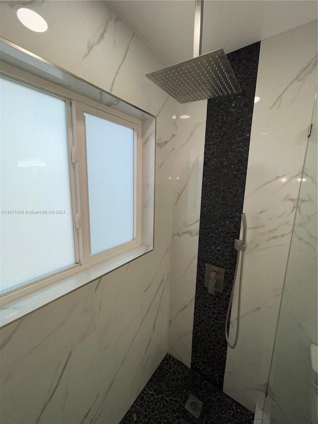 bathroom with a tile shower