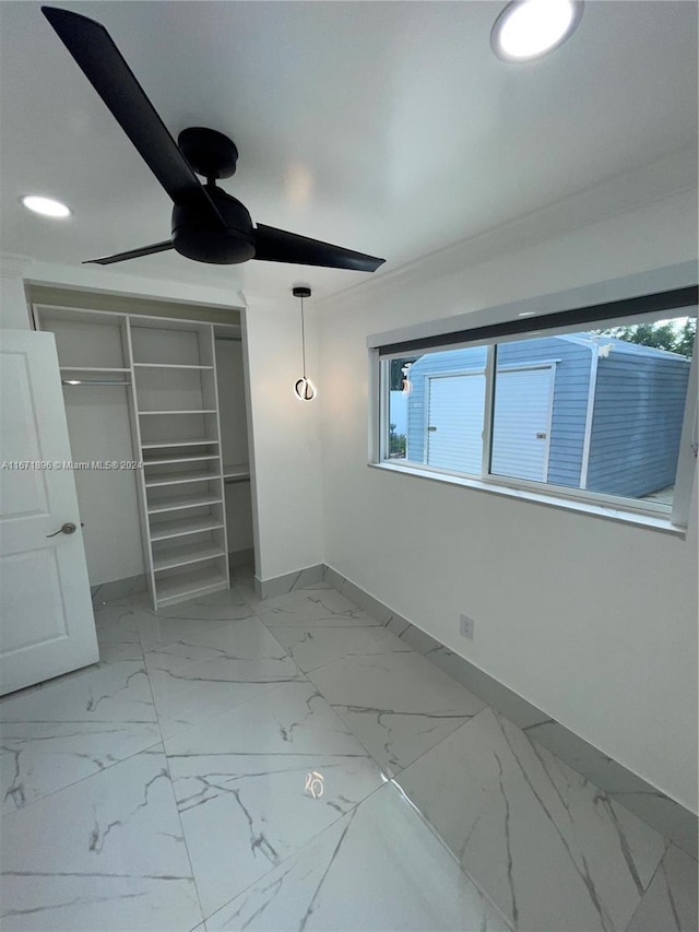 unfurnished bedroom with a closet, ceiling fan, and ornamental molding