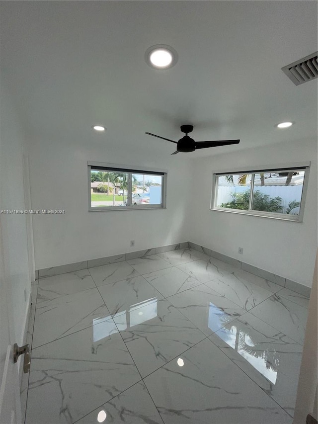 spare room with plenty of natural light and ceiling fan