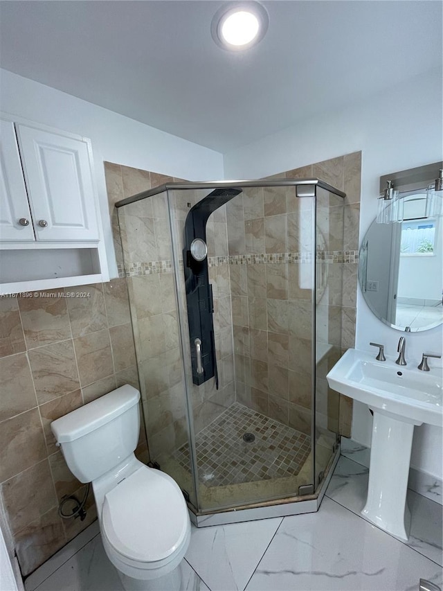 bathroom with toilet and an enclosed shower