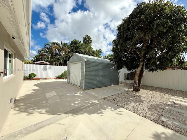 view of patio featuring an outdoor structure and a garage