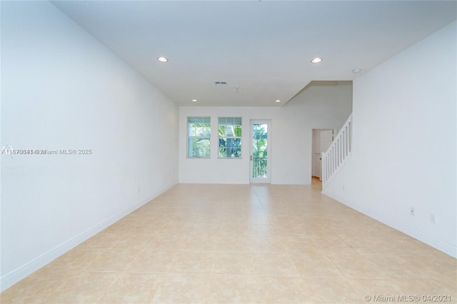 unfurnished living room featuring recessed lighting, baseboards, visible vents, stairway, and light tile patterned flooring