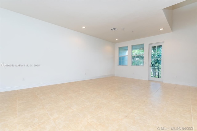 empty room featuring recessed lighting, visible vents, and baseboards