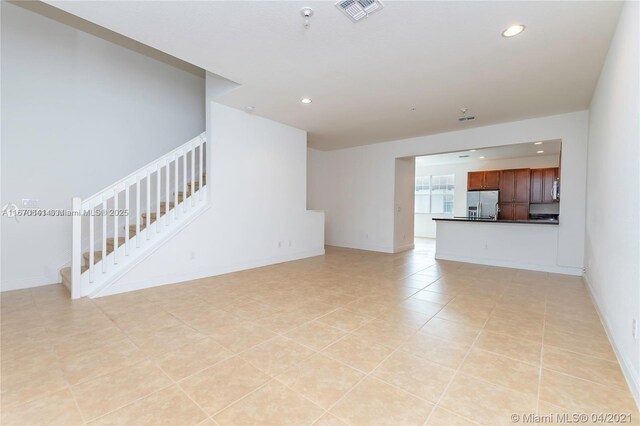 unfurnished room with light tile patterned floors