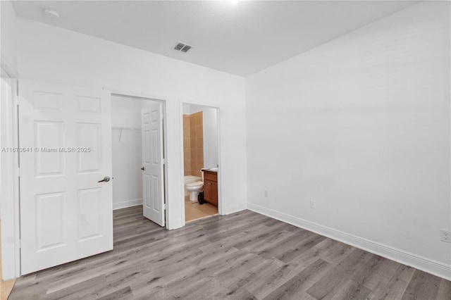 11959 SW 26th Ct, Miramar, FL 33025 - unfurnished bedroom with light wood-style flooring, visible vents, a closet, baseboards, and a walk in closet
