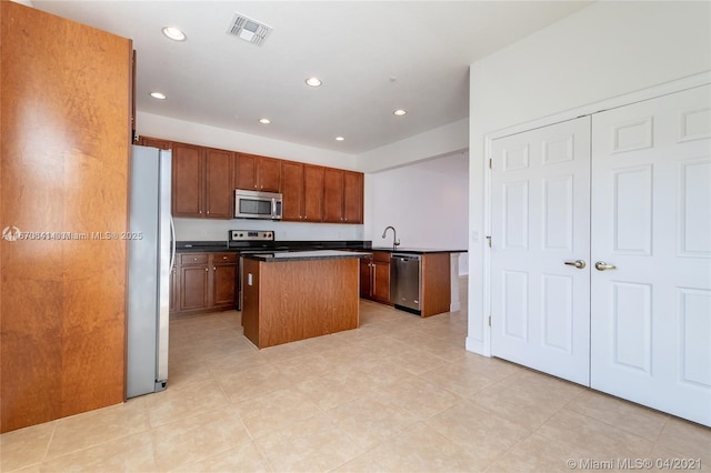 kitchen featuring appliances with stainless steel finishes and a kitchen island