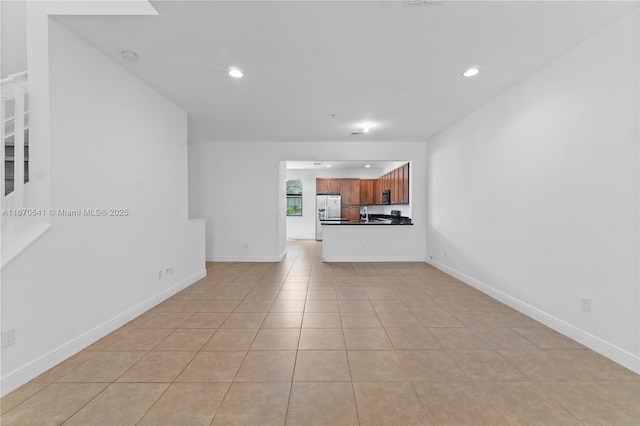 11959 SW 26th Ct, Miramar, FL 33025 - unfurnished living room with light tile patterned floors, recessed lighting, and baseboards
