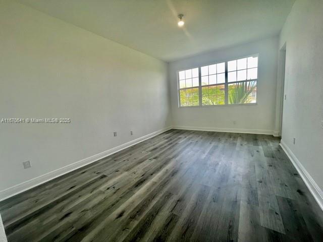 empty room featuring dark hardwood / wood-style flooring