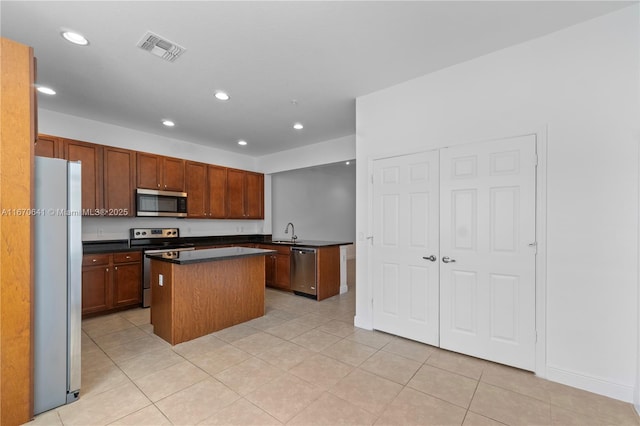 11959 SW 26th Ct, Miramar, FL 33025 - kitchen with recessed lighting, stainless steel appliances, dark countertops, a center island, and visible vents