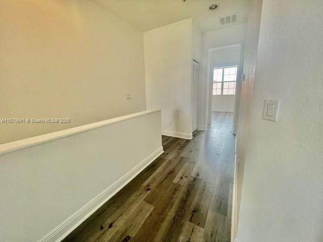 walk in closet with hardwood / wood-style flooring