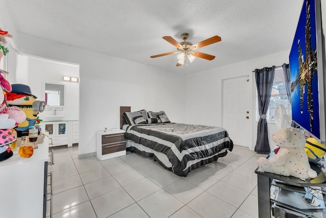 tiled bedroom with ceiling fan, sink, and a textured ceiling