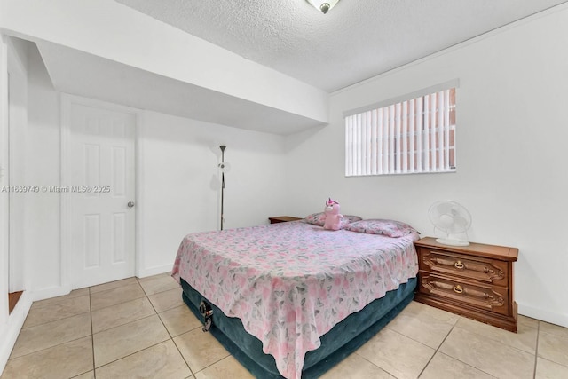 tiled bedroom featuring a textured ceiling