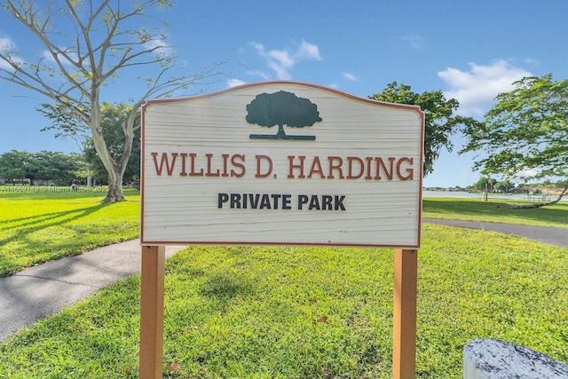 community / neighborhood sign with a lawn