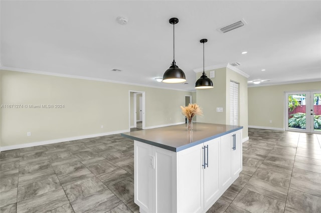 kitchen featuring white cabinetry, crown molding, a center island, pendant lighting, and french doors