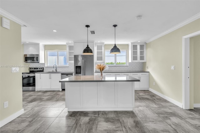 kitchen with white cabinetry, a wealth of natural light, stainless steel appliances, and sink