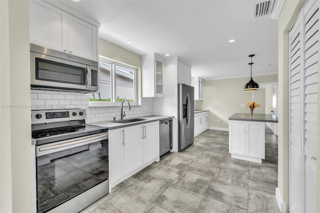 kitchen with decorative light fixtures, white cabinetry, sink, and stainless steel appliances