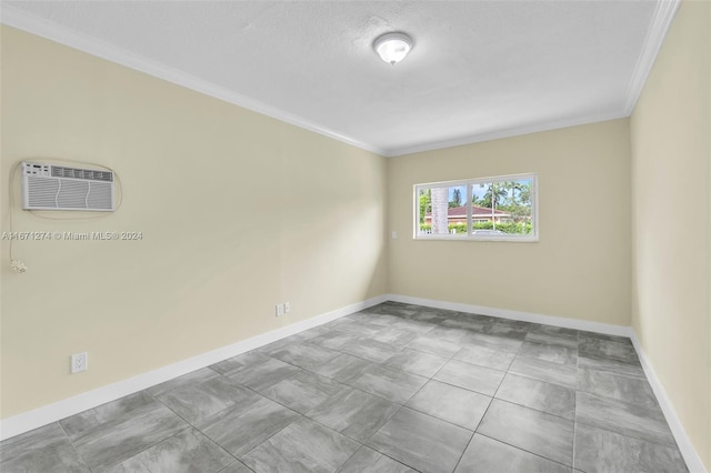 spare room featuring a wall mounted AC and crown molding