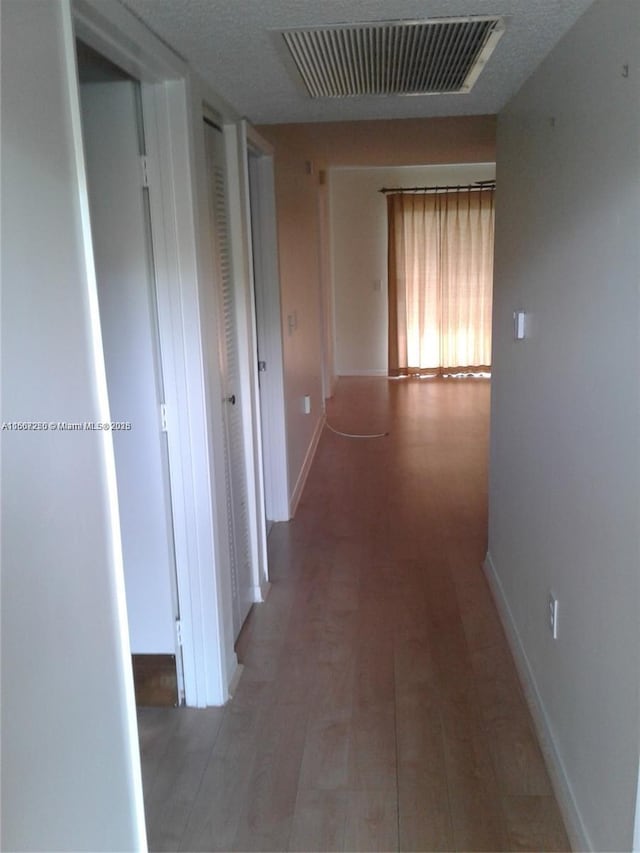 701 SW 142nd Ave Unit 104S, Pembroke Pines, FL 33027 - hallway with baseboards and wood finished floors