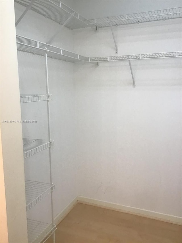 701 SW 142nd Ave Unit 104S, Pembroke Pines, FL 33027 - spacious closet featuring wood finished floors