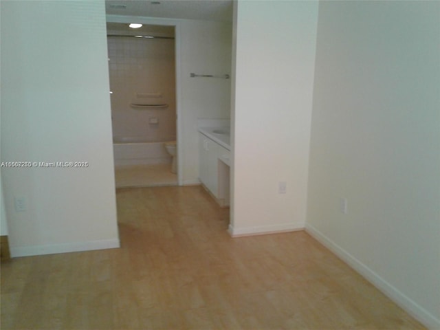 701 SW 142nd Ave Unit 104S, Pembroke Pines, FL 33027 - hall featuring baseboards and light wood-style flooring