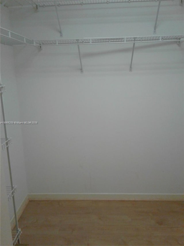 701 SW 142nd Ave Unit 104S, Pembroke Pines, FL 33027 - walk in closet featuring light wood finished floors