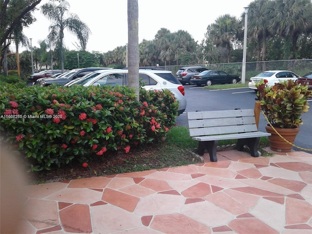 701 SW 142nd Ave Unit 104S, Pembroke Pines, FL 33027 - uncovered parking lot featuring view of wooded area