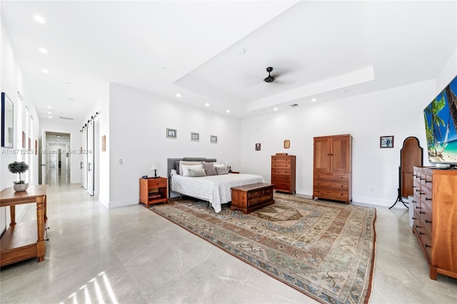 bedroom with a raised ceiling and ceiling fan