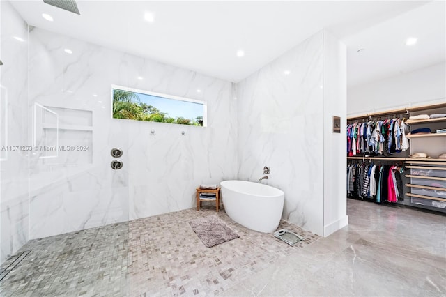 bathroom featuring independent shower and bath and tile walls