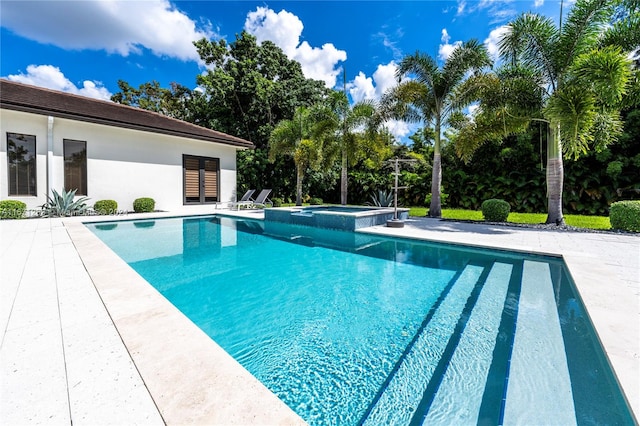 view of swimming pool with an in ground hot tub and a patio