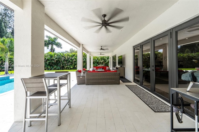 view of patio featuring french doors, an outdoor living space, and ceiling fan