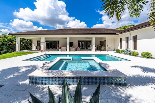 view of pool featuring an in ground hot tub, a patio, and ceiling fan