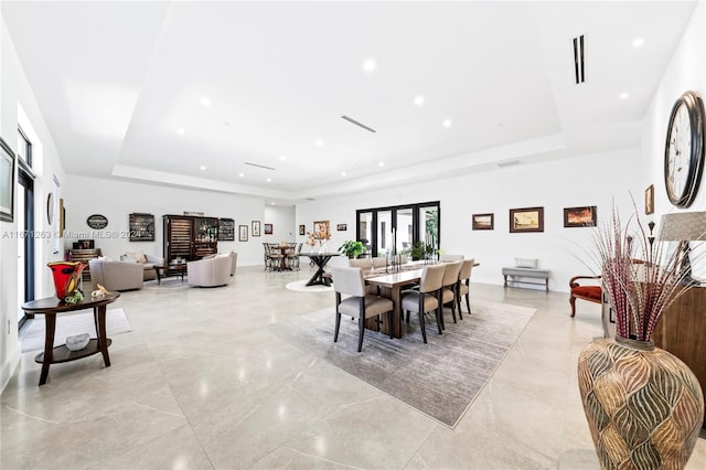 dining space featuring a raised ceiling