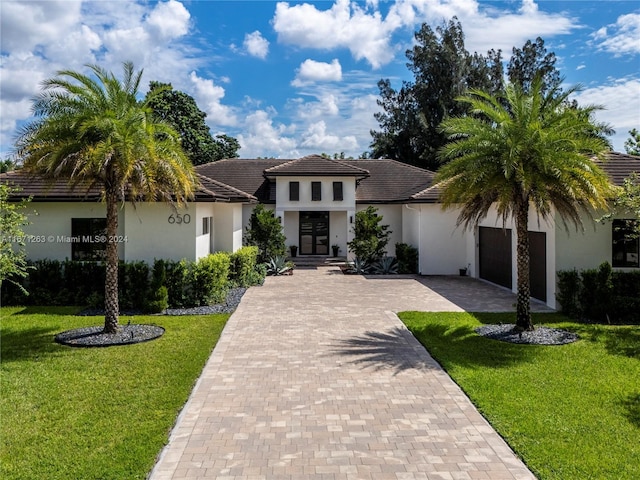 mediterranean / spanish house with a front lawn