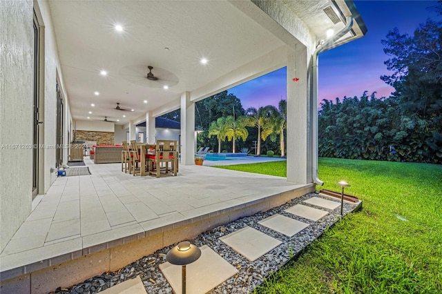 view of patio / terrace featuring ceiling fan and a pool