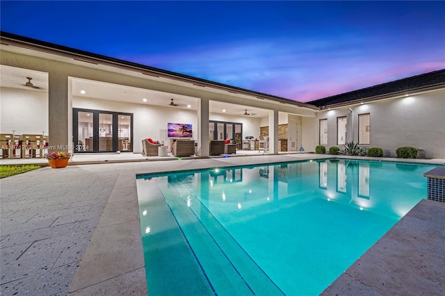 view of swimming pool featuring a patio area and ceiling fan