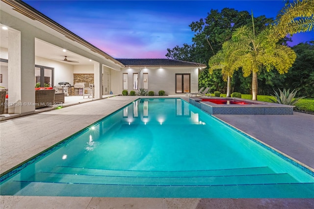 pool at dusk featuring a patio area and ceiling fan