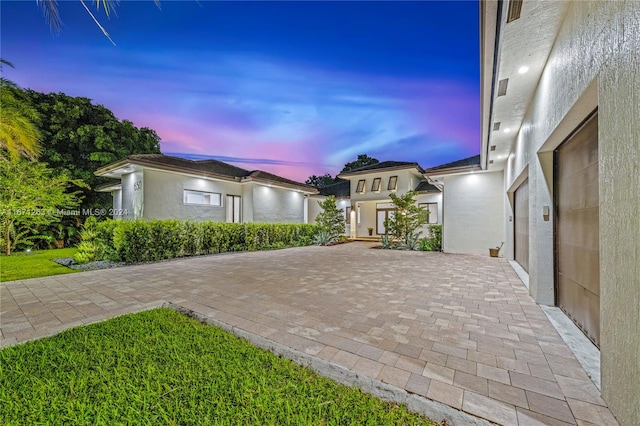 view of front of home featuring a yard and a patio area