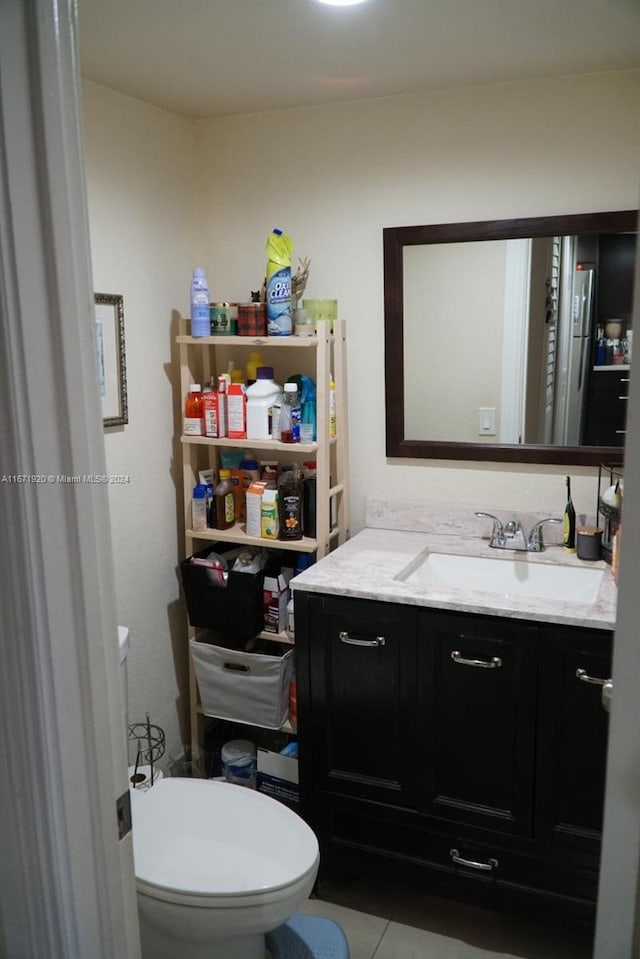 bathroom with tile patterned floors, vanity, and toilet