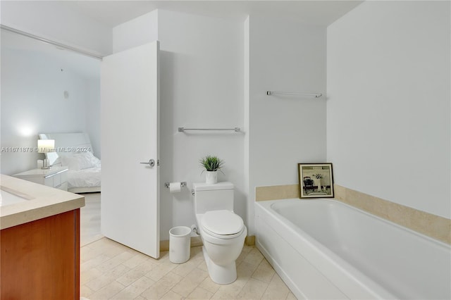 bathroom with vanity, toilet, and a bathing tub