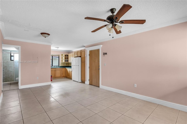 unfurnished living room with light tile patterned flooring, sink, a textured ceiling, ornamental molding, and ceiling fan