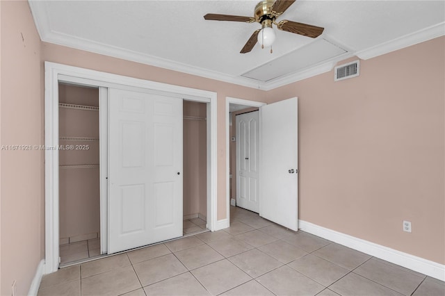 unfurnished bedroom featuring ceiling fan, ornamental molding, a closet, and light tile patterned floors