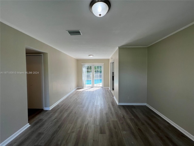 corridor with french doors, ornamental molding, and dark hardwood / wood-style flooring