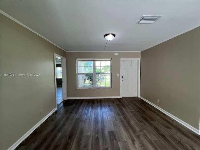 unfurnished room with ornamental molding and dark hardwood / wood-style floors