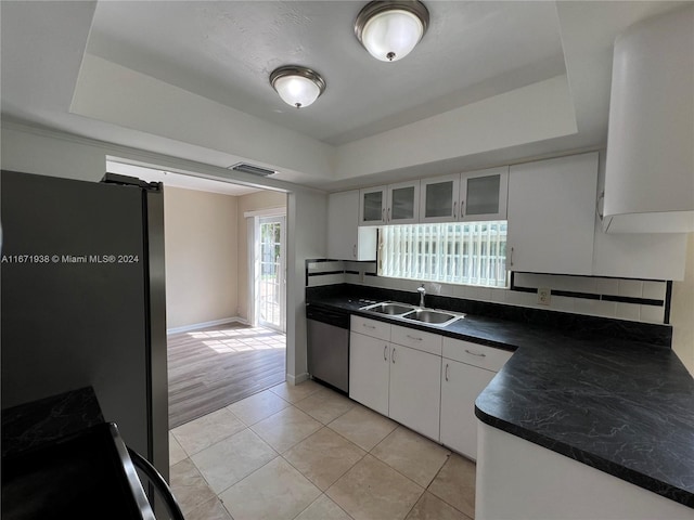 kitchen featuring white cabinets, stainless steel appliances, sink, and light hardwood / wood-style flooring